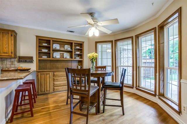 7215 Hillwood Ln, Dallas, TX 75248 - dining area with light wood finished floors, ornamental molding, and ceiling fan