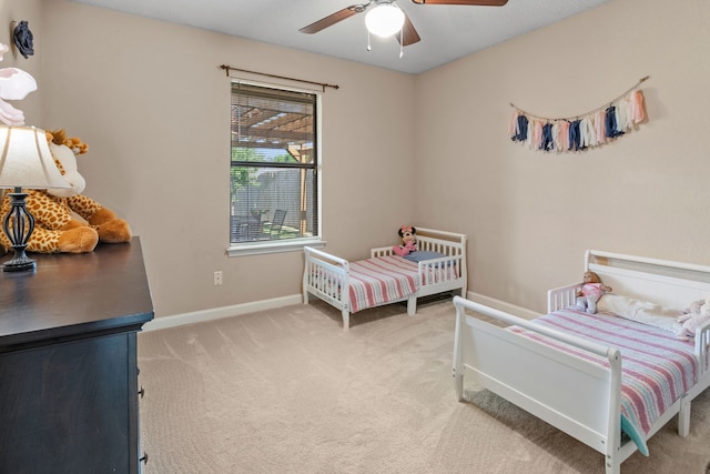 bedroom featuring baseboards, ceiling fan, and light carpet