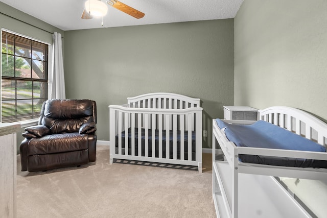 carpeted bedroom with a ceiling fan and baseboards