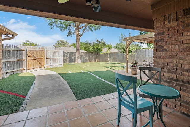 view of patio with a fenced backyard, a ceiling fan, and a gate