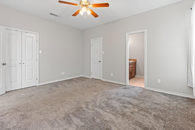 305 S 1st St, Grandview, TX 76050 - unfurnished bedroom with visible vents, carpet floors, baseboards, ceiling fan, and ensuite bath