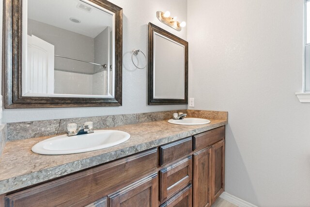 305 S 1st St, Grandview, TX 76050 - full bath with double vanity, a sink, and visible vents