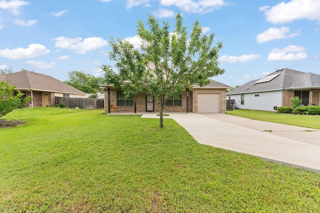 305 S 1st St, Grandview, TX 76050 - view of front of home with a front lawn, fence, brick siding, an attached garage, and driveway