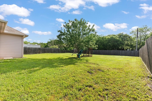 305 S 1st St, Grandview, TX 76050 - view of yard featuring a fenced backyard and a playground