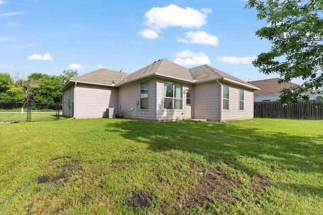 305 S 1st St, Grandview, TX 76050 - rear view of house featuring a fenced backyard, central AC, and a yard