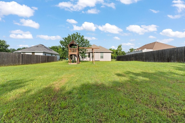 305 S 1st St, Grandview, TX 76050 - view of yard featuring a fenced backyard and a playground