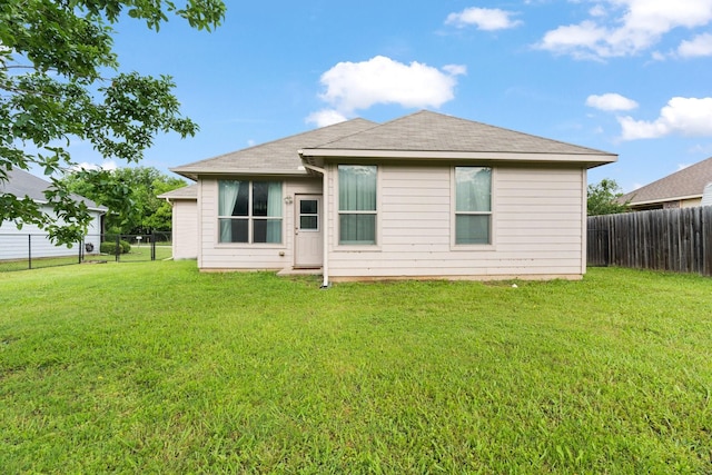 305 S 1st St, Grandview, TX 76050 - back of property featuring a lawn and a fenced backyard