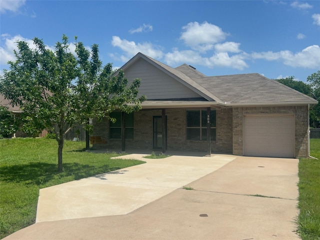 305 S 1st St, Grandview, TX 76050 - view of front of home featuring brick siding, an attached garage, driveway, and a front lawn