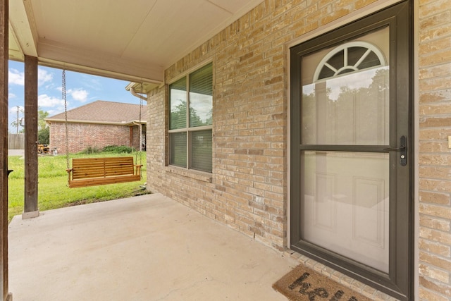 305 S 1st St, Grandview, TX 76050 - view of exterior entry featuring a yard, a porch, and brick siding