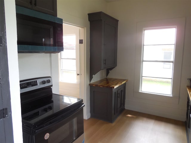 kitchen with electric range and light wood-style flooring