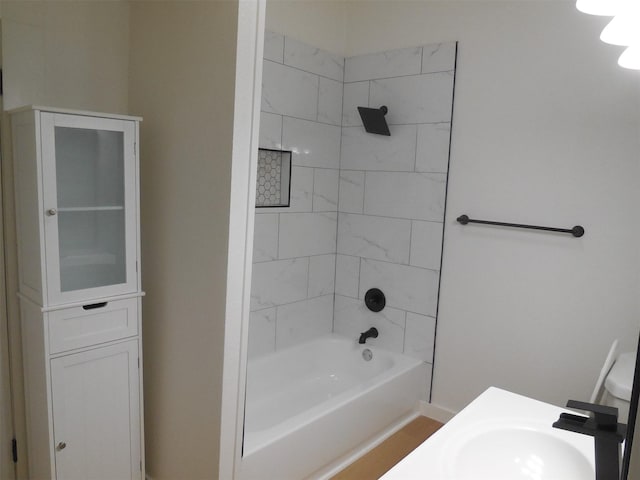 bathroom with shower / washtub combination and a sink