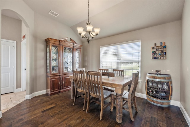 4339 Paige Dr, Caddo Mills, TX 75135 - dining space with lofted ceiling, a chandelier, dark wood-style floors, and arched walkways