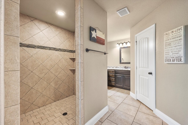 4339 Paige Dr, Caddo Mills, TX 75135 - full bath with tiled shower, tile patterned flooring, vanity, baseboards, and visible vents