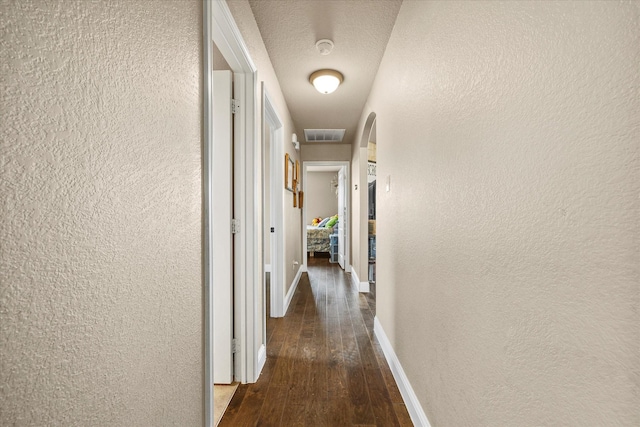 4339 Paige Dr, Caddo Mills, TX 75135 - hall featuring a textured wall, baseboards, visible vents, and wood-type flooring