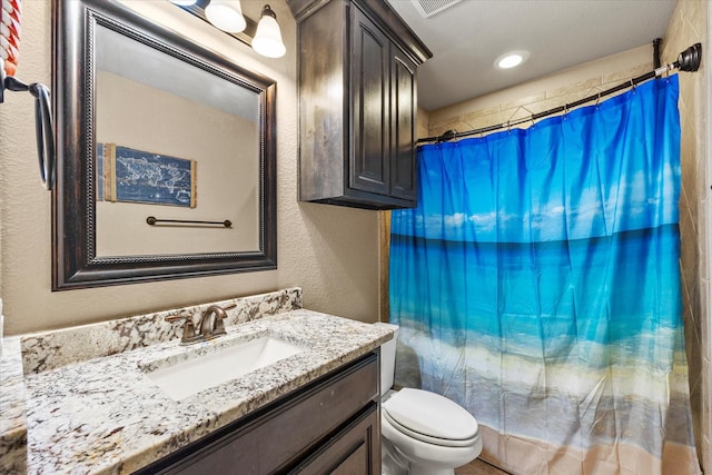 4339 Paige Dr, Caddo Mills, TX 75135 - bathroom featuring a shower with shower curtain, toilet, a textured wall, and vanity