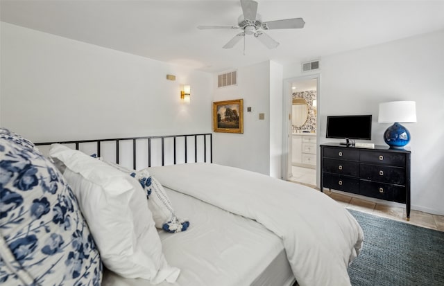 tiled bedroom featuring visible vents, ceiling fan, and ensuite bathroom