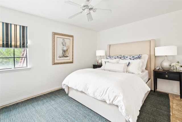 bedroom featuring a ceiling fan and baseboards