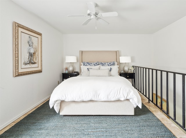 bedroom with ceiling fan and baseboards