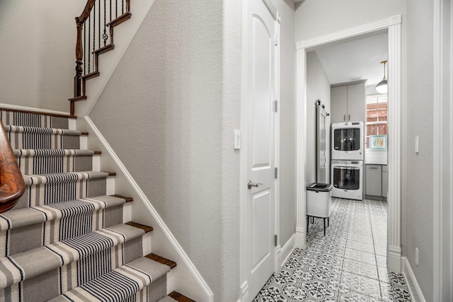 stairway with tile patterned floors and baseboards