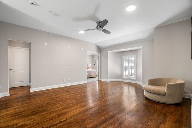 unfurnished room featuring baseboards, wood finished floors, and ceiling fan