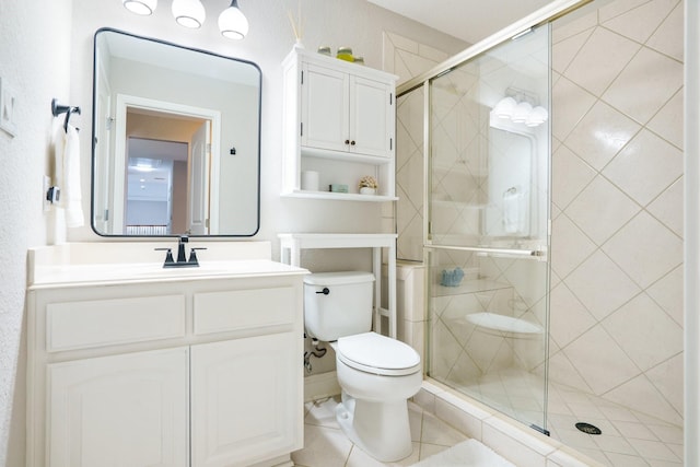 bathroom with a stall shower, toilet, and vanity