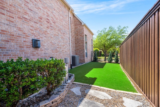 view of yard featuring cooling unit and fence