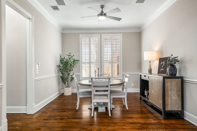 dining space with wood finished floors, ceiling fan, baseboards, visible vents, and crown molding