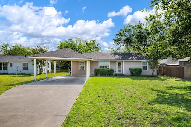 ranch-style house with concrete driveway, a front lawn, an attached carport, and fence