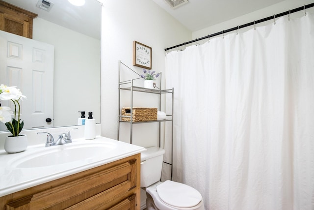 bathroom with visible vents, toilet, a shower with curtain, and vanity