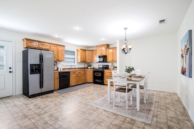 kitchen with stone finish floor, visible vents, a chandelier, baseboards, and black appliances