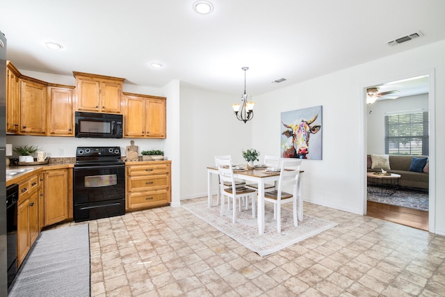 kitchen featuring black appliances, stone finish floor, visible vents, and light countertops