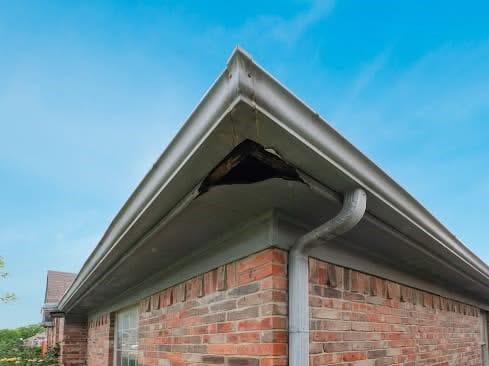 exterior details featuring brick siding