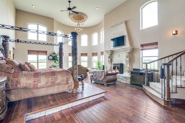 living room featuring stairway, a healthy amount of sunlight, a ceiling fan, and a high ceiling