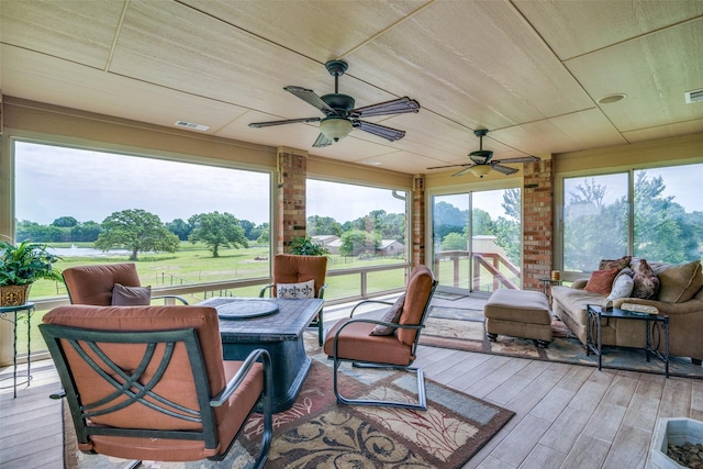 exterior space featuring outdoor lounge area, a wooden deck, ceiling fan, and wood finished floors