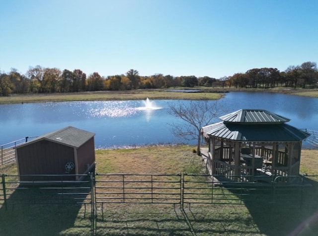 view of dock with a water view and an exterior structure