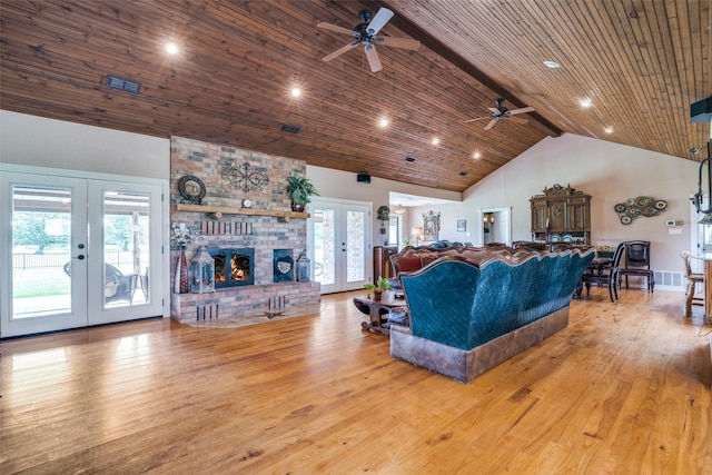 living room with wood finished floors, french doors, ceiling fan, and high vaulted ceiling
