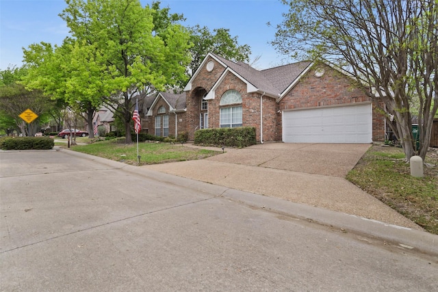 view of front of home featuring concrete driveway, a shingled roof, brick siding, and a garage