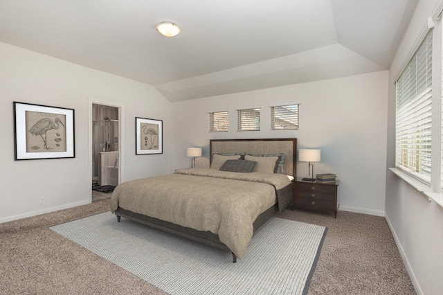 carpeted bedroom with baseboards and vaulted ceiling