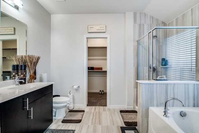full bathroom with a shower stall, toilet, a garden tub, and a spacious closet