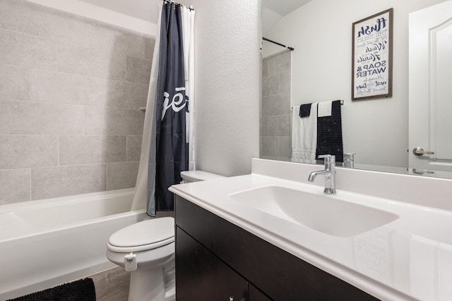 bathroom featuring vanity, toilet, wood finished floors, and shower / tub combo