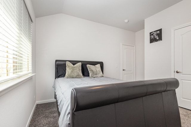 bedroom with baseboards, carpet, and vaulted ceiling