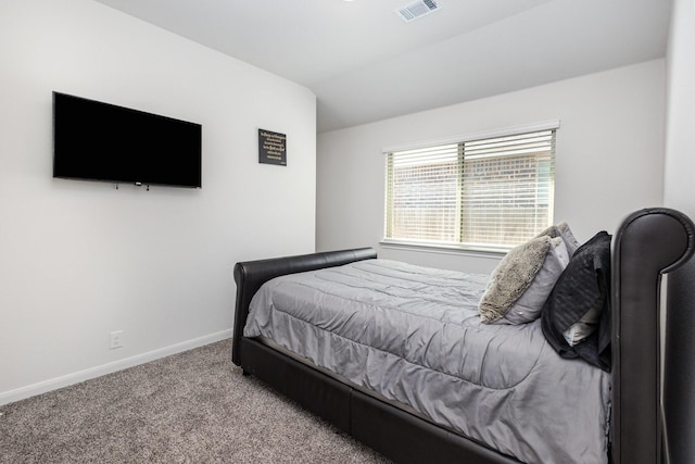 carpeted bedroom featuring baseboards, vaulted ceiling, and visible vents
