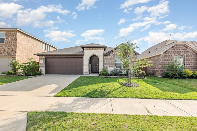 view of front of house with a front lawn, stone siding, roof with shingles, an attached garage, and driveway