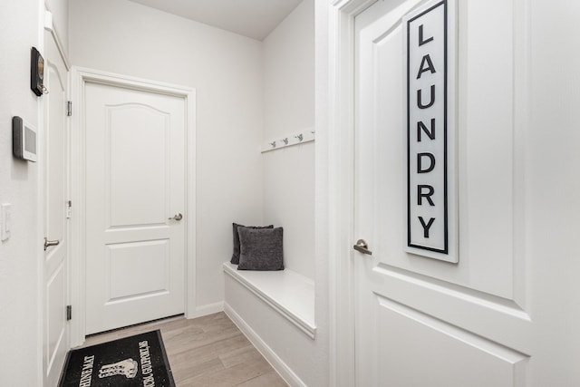 mudroom featuring baseboards and light wood-style floors
