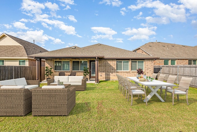 back of house with an outdoor living space, a fenced backyard, brick siding, and a shingled roof