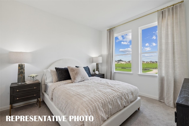 carpeted bedroom with baseboards