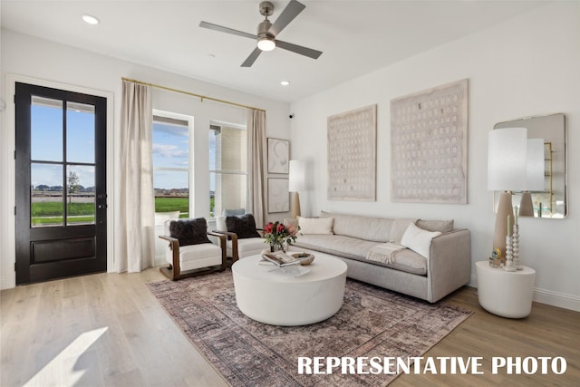 living area featuring recessed lighting, ceiling fan, wood finished floors, and baseboards