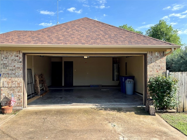 207 Shary St, Aledo, TX 76008 - garage featuring water heater, fence, and concrete driveway