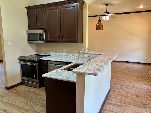207 Shary St, Aledo, TX 76008 - kitchen featuring a sink, stainless steel appliances, a ceiling fan, a peninsula, and dark brown cabinets