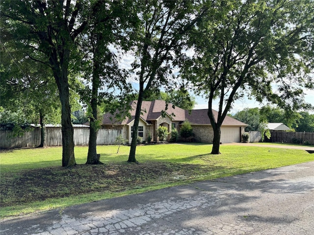 207 Shary St, Aledo, TX 76008 - view of front of home featuring fence, driveway, a front yard, and an attached garage